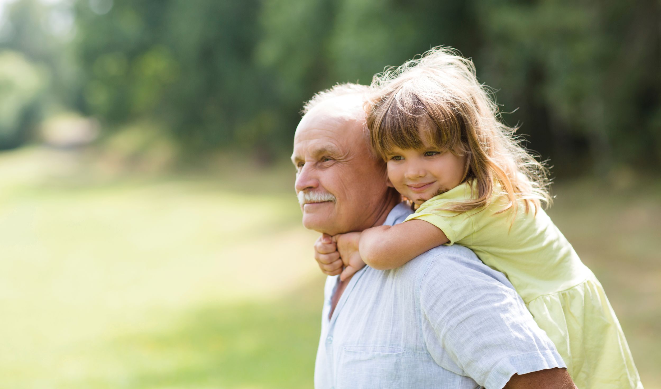 Little,Child,Girl,Hugs,Grandpa,On,Walk,In,The,Summer Little child girl hugs grandpa On Walk in the summer outdoors. Concept of friendly family.